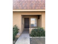 Inviting condo entry with tiled walkway, landscaping, and a covered entryway at 426 W Pontiac Dr # 6, Phoenix, AZ 85027