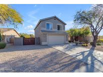 Two-story house with a beige exterior, two-car garage, and desert landscaping at 4529 E Coyote Wash Dr, Cave Creek, AZ 85331