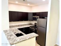 Modern kitchen with granite countertops and stainless steel appliances at 6900 E Princess Dr # 2128, Phoenix, AZ 85054