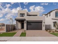 Modern two-story home with dark garage door and landscaped front yard at 10236 E Ursula Ave, Mesa, AZ 85212