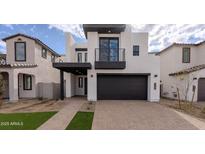 Modern two-story home with a two-car garage and balcony at 10249 E Ulysses Ave, Mesa, AZ 85212