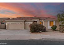 Beautiful one-story home with a two-car garage and landscaped front yard at 10310 E Posada Ave, Mesa, AZ 85212