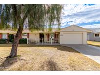 Ranch style home with carport and mature landscaping at 10343 W Prairie Hills Cir, Sun City, AZ 85351