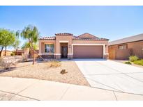 One-story house with brown garage door and stone accents at 1263 E Denvil Dr, Casa Grande, AZ 85122