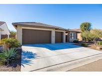 Two-car garage, desert landscaping, and neutral-colored exterior at 16925 W Virginia Ave, Goodyear, AZ 85395