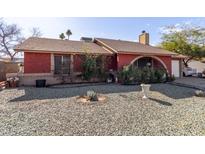 Ranch style home with red exterior, stone pathway, and mature landscaping at 6433 W Cortez St, Glendale, AZ 85304