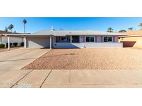 Single-story home with carport and desert landscaping at 10020 N 109Th Ave, Sun City, AZ 85351