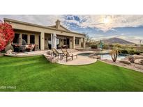 Inviting pool and spa with artificial turf and mountain backdrop at 12026 N 138Th St, Scottsdale, AZ 85259