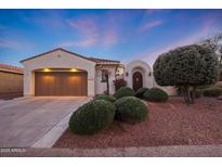 Single-story home with a two-car garage and landscaped front yard at 13129 W Junipero Dr, Sun City West, AZ 85375