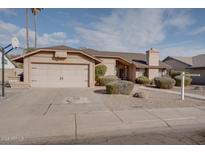 Single-story house with a two-car garage and well-manicured landscaping at 1354 E Brentrup Dr, Tempe, AZ 85283