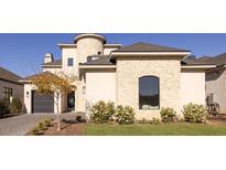 Stunning two-story home with stone accents and a three-car garage at 20684 E Natalie Way, Queen Creek, AZ 85142