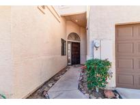 Inviting front entrance with wrought iron door and landscaping at 23570 N 75Th N St, Scottsdale, AZ 85255