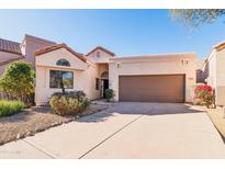 Charming house exterior with a two-car garage at 23570 N 75Th N St, Scottsdale, AZ 85255