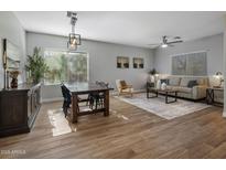 Bright dining area with wood table and chairs, hardwood floors, and natural light at 27121 N 84Th Dr, Peoria, AZ 85383