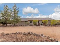 Ranch style home with rock wall accents and mature landscaping at 313 W Saddle Mountain Rd, Phoenix, AZ 85086