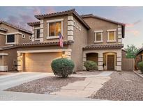 Two-story house with tan exterior, landscaped yard, and a two-car garage at 33610 N 26Th Ave, Phoenix, AZ 85085