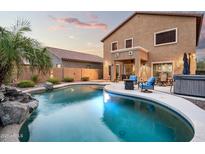 Inviting backyard oasis with a large pool, spa, and comfortable patio furniture at 33610 N 26Th Ave, Phoenix, AZ 85085