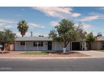 White single story house with a landscaped front yard and a two car garage at 3426 W Elm St, Phoenix, AZ 85017