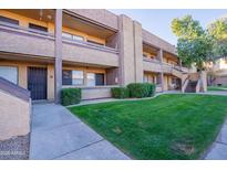 Attractive condo building with landscaping and walkway at 3535 W Tierra Buena Ln # 156, Phoenix, AZ 85053