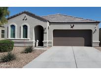 Charming single-story home featuring desert landscaping, a two-car garage, and a welcoming front entrance at 4916 E Rhodium Dr, San Tan Valley, AZ 85143