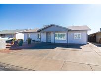 Newly painted home with a spacious front yard and driveway at 7217 W Claremont St, Glendale, AZ 85303