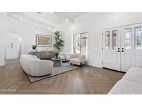 Bright living room featuring stylish seating, herringbone floors, and plenty of natural light at 9031 N 83Rd Way, Scottsdale, AZ 85258