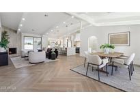 Open living area with herringbone floors, fireplace, and ample natural light at 9031 N 83Rd Way, Scottsdale, AZ 85258