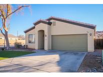 Single-story home with a two-car garage and well-manicured lawn at 10549 E Flossmoor Ave, Mesa, AZ 85208