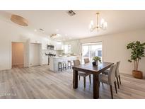 Bright kitchen features island, white cabinets, and modern appliances at 10811 E Contessa St, Mesa, AZ 85207