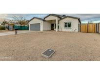 Newly built home with gray garage door and neutral exterior at 10869 N 81St Ave, Peoria, AZ 85345