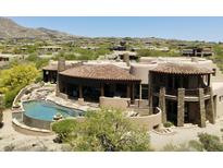 Stunning aerial view of home with private pool, stone accents, and desert landscaping in a picturesque community at 11105 E Tamarisk Way, Scottsdale, AZ 85262