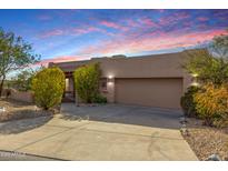 Tan stucco house with a two-car garage and desert landscaping at 11686 N Spotted Horse Way, Fountain Hills, AZ 85268