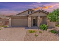 One-story home with brown garage door and stone accents at 16019 W Avenida Del Sol --, Surprise, AZ 85387