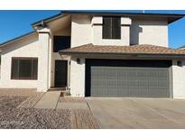 Two-story house with gray garage door and landscaped walkway at 1722 W Brooks St, Chandler, AZ 85224