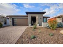 Charming single-story home featuring desert landscaping, neutral colors, and an attached two-car garage at 17527 E Silver Sage Ln, Rio Verde, AZ 85263