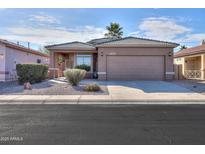 One-story home with a two-car garage and landscaped front yard at 1861 E Birch St, Casa Grande, AZ 85122