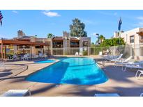 Community pool and spa with lounge chairs and covered patio at 205 N 74Th St # 122, Mesa, AZ 85207