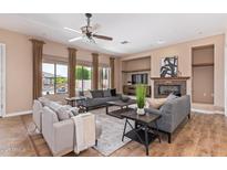 Spacious living room with fireplace and large windows at 23242 S 202Nd Way, Queen Creek, AZ 85142