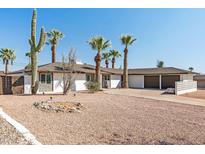 White mid-century modern home with desert landscaping and two-car garage at 2826 E Victor Hugo Ave, Phoenix, AZ 85032