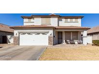 Two-story house with a white garage door and brown roof at 29808 N Yellow Bee Dr, San Tan Valley, AZ 85143