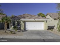 One-story house with a white garage door and landscaped yard at 40112 W Catherine Dr, Maricopa, AZ 85138