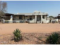 Single-story home with stucco exterior, covered porch, and gated entry at 50134 W Gail Ln, Maricopa, AZ 85139