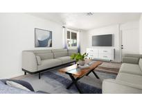 Living room with comfy sofas and a wooden coffee table at 5031 W Flynn Ln, Glendale, AZ 85301