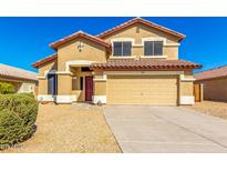 Charming two-story home featuring a red tile roof, beige stucco, and attached two-car garage at 6410 W Hughes Dr, Phoenix, AZ 85043