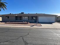 Ranch style home with a two-car garage and desert landscaping at 6449 E Dodge St, Mesa, AZ 85205