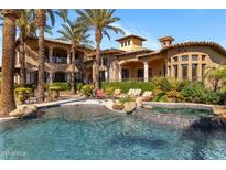Resort style pool and spa with swaying palms perfect for outdoor entertaining in this luxury home at 6876 S Star Dr, Gilbert, AZ 85298