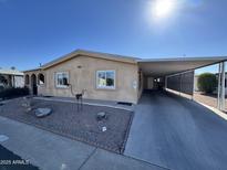 Single-story home with carport and desert landscaping at 8103 E Southern Ave # 52, Mesa, AZ 85209