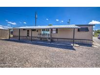 Mobile home with carport and gravel driveway at 9310 E Main St # 182, Mesa, AZ 85207