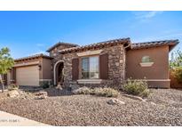 Single-story home with stone accents and a three-car garage at 12061 W Miner Trl, Peoria, AZ 85383