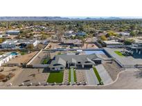 Aerial view of a modern home with a pool and landscaped yard, in a residential neighborhood at 12075 N 76Th Ct, Scottsdale, AZ 85260